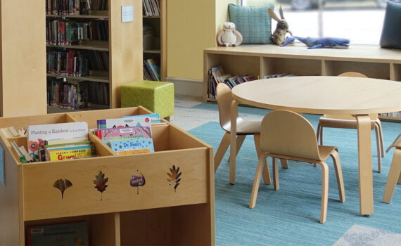 Children's wooden chairs and wood leg table, wooden book bin, custom end panels at Glen Lake Library